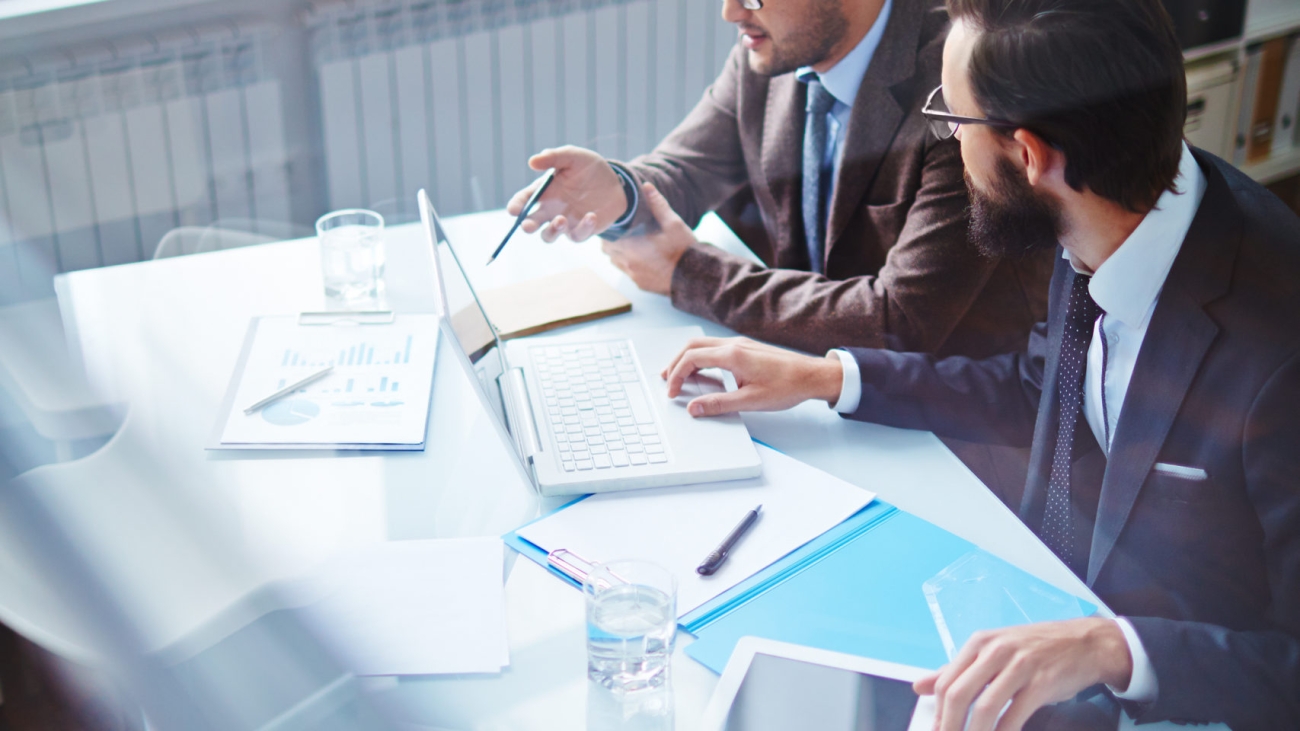 Two business partners discussing plans and strategies in office